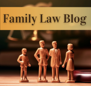Wooden toy family figurines stand before a judge's gavel. Caption "Family Law Blog"